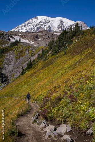 Hiker on a trail at Mt. Rainier National Park in early fall 