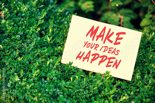 Motivational quote make your ideas happen written on paper in a garden with green plants in nature. Achievement or accomplishment in life or business.