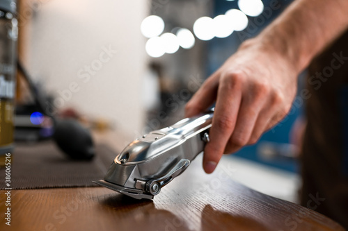 Barber master picks up a hair clipper