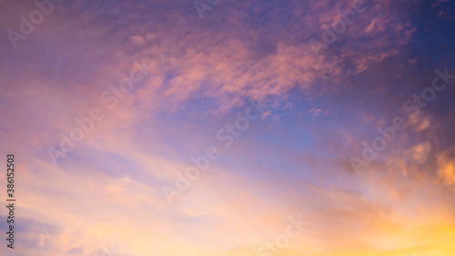 Multicolored clouds during sunset. Clouds, purple, hazy, blue and violet sky, hints of yellow