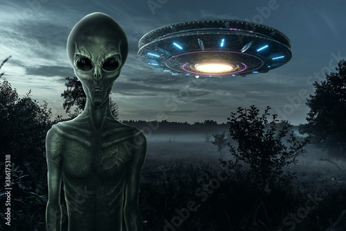 Green alien with black large glass eyes on the background of a flying saucer. UFO concept, aliens, contact with extraterrestrial civilization