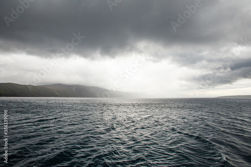 Dramatic image of agitated sea near mountain island, Croatia.