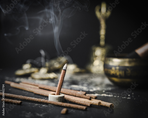 Tibetan incense with ritual things on background