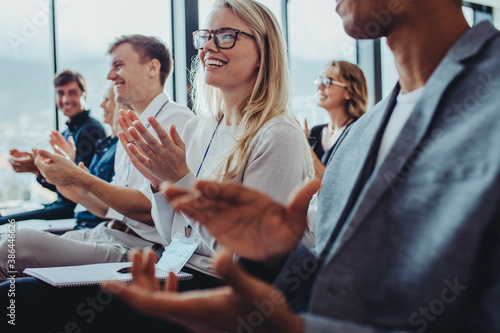 Business professionals applauding at a seminar