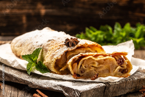 Homemade apple strudel with fresh apples and powdered sugar. classic and probably the best known Viennese pastry outside of Austria