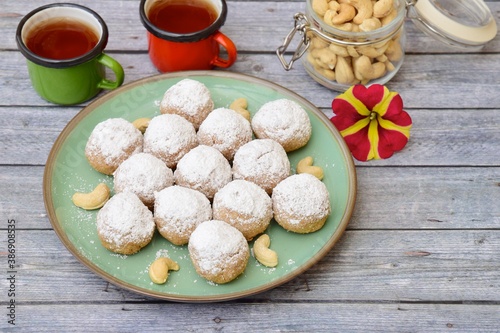 Kue Putri Salju Kacang Mede or "snow princess" white ball cookies made from cashew, egg yolk, flour, corn starch and butter coated with powdered sugar. 