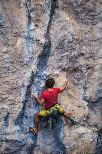 A strong man climbs a rock, Rock climbing in Turkey.