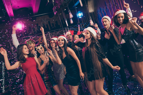 Photo of funny dreamy people meeting dance have fun hold glass wear mini dress x-mas headwear modern club indoors