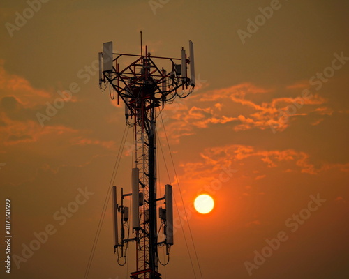 4G and 5G cellular. Macro Base Station or Base Transceiver Station. Telecommunication tower. Wireless Communication Antenna Transmitter. Development of communication systems in urban area at sunset.