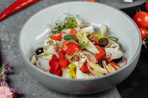 Traditional greek salad with fresh vegetables, feta cheese and olives. Top view. Selective focus