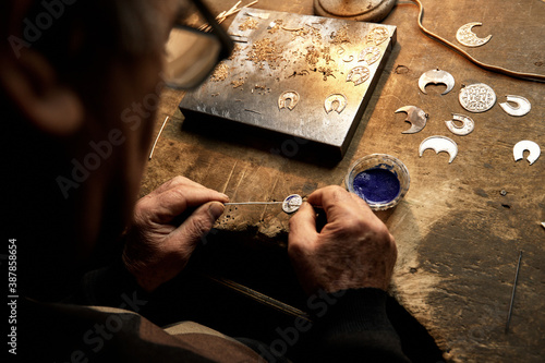 Hand-made silver items with cloisonné enamel in progress. Traditional work in the mountain village of Kubachi, Dagestan.