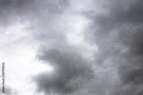 black and white storm clouds background. Light in the Dark and Dramatic Storm Clouds background, Dark clouds before a thunder-storm.
