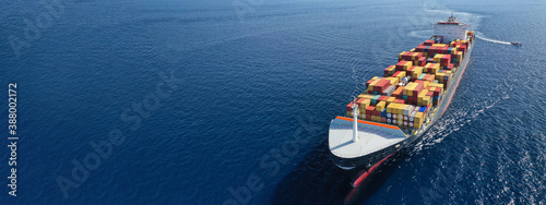 Aerial drone panoramic ultra wide photo of industrial truck size container tanker ship cruising in open ocean deep blue sea