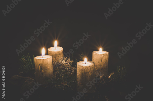 four burning candles on advent wreath