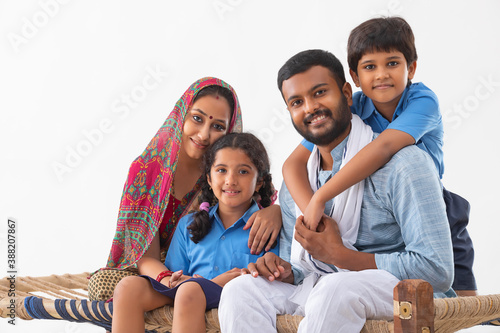 PORTRAIT OF A COMPLETE RURAL FAMILY HAPPILY LOOKING AT CAMERA 