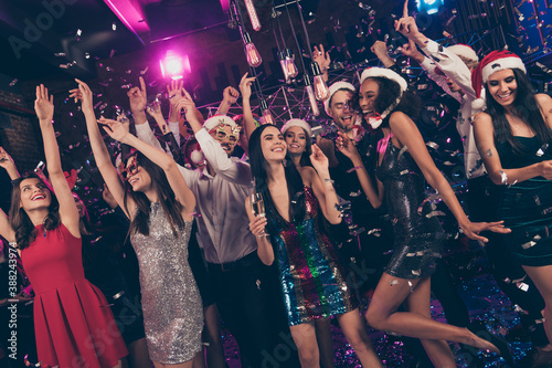 Photo of charming funky people x-mas gathering falling sparkles hold glass champagne dance floor modern club indoors