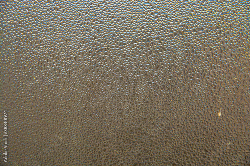 background of water drops or dew on glass in the form of a pattern