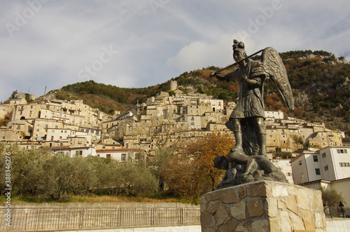 In the foreground the statue of San Michele and the dragon and in the background the characteristic village of Pesche - Isernia