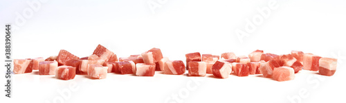 Smoked bacon cubes on kitchen counter, isolated on white background.