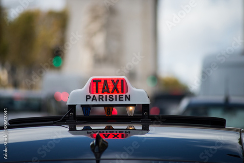 Paris - France - 24 October 2020 - Closeup of parisian taxi sign on a car roof in the street