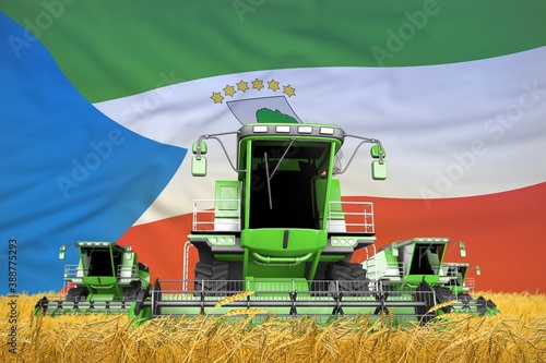 4 light green combine harvesters on grain field with flag background, Equatorial Guinea agriculture concept - industrial 3D illustration