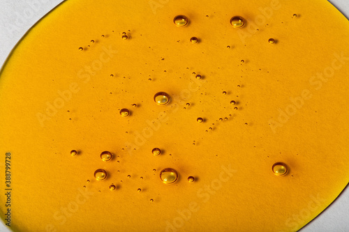 Yellow viscous liquid lecithin with bubbles on glass