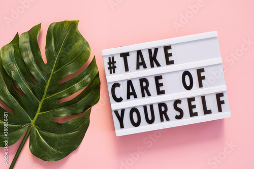 Lightbox with words Take Care of Yourself on pink background
