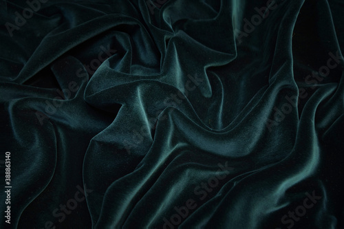 Texture, background, pattern. Texture of green velvet fabric. Beautiful emerald green soft velvet fabric.