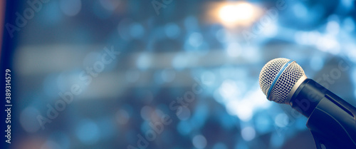 Public speaking backgrounds, Close-up the microphone on stand for speaker speech the seminar room with technology light background and blur bokeh.