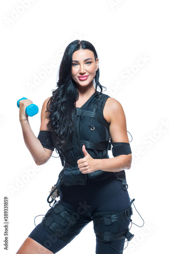 A young athletic woman in an EMS suit shows like on an isolated white background. EMS training. Electrical muscle stimulator.