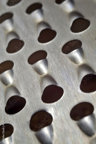 metal kitchen grater with large holes. macro.