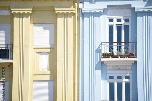 Closeup of pilasters on the facade of the beige and blue building