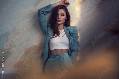 Fashion portrait of female model on art background. stylish clothes and accessories. concept of garmonical style and atmosphere. added noise effect on photo