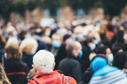 Rear view of people gathering at a protest all of them wearing protective masks due to COVID-19 coronavirus epidemic situation