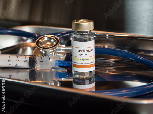 Vial of interferons injection with stethoscope and syringe
