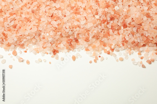 Pink himalayan salt on white background, space for text