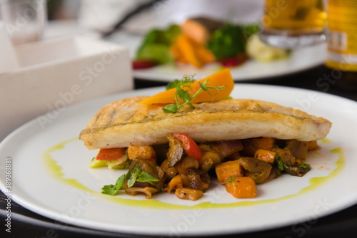 Fish dish served on a white plate.