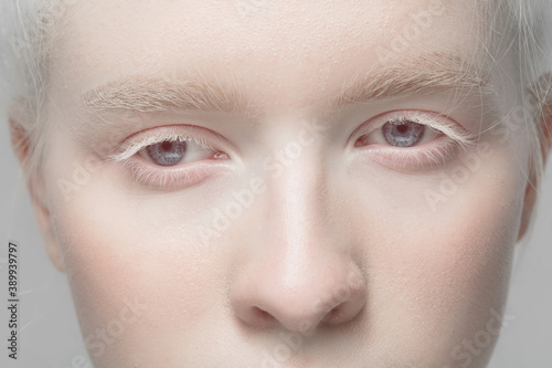 Nose and eyelid. Close up portrait of beautiful albino female model. Parts of face and body. Beauty, fashion, skincare, cosmetics, wellness concept. Copyspace. Well-kept skin, fresh look, details.