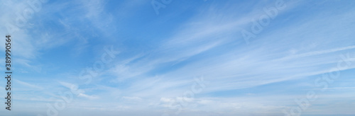 Blue sky with beautiful wispy clouds. Panoramic background.