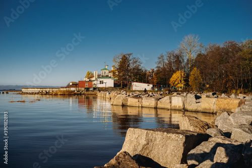 rocky coast of wild beach near life-boat station. Bank of gulf of finland on sunny october day. Calm sea concept