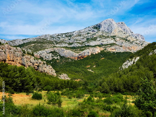 Magnificent landscape of Provence near Aix en Provence with the majestic Sainte-Victoire mountain surrounded by verdant nature and overlooked by a beautiful blue sky