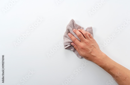 A man's hand on a white background with a rag