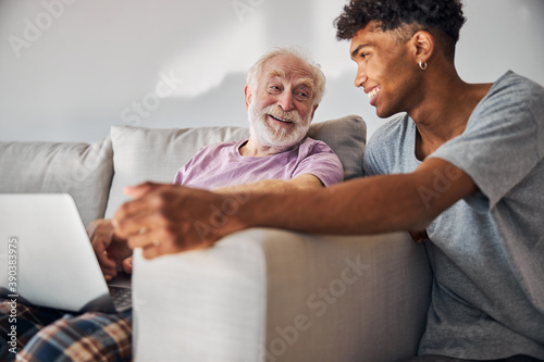 Cheerful pensioner and a volunteer spending time together