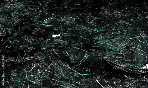 pieces of Shattered and broken glass isolated on black background