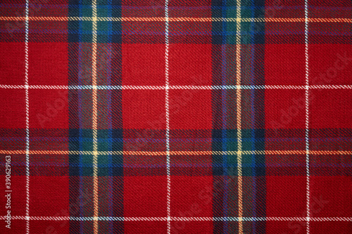 Red tartan plaid material background. Christmas pattern.