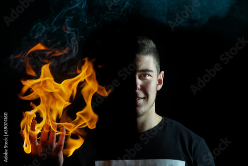 A portrait of a guy holding fire in right hand, (Half face portrait.