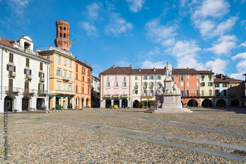 Beautiful square in an old city in Italy. Historic center of Vercelli. Square Cavour with the monument to Cavour of 1864 and the Angel tower (14th-17th century), symbol of the city 