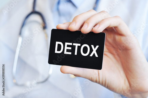 Doctor holding a paper card with text Detox, medical concept