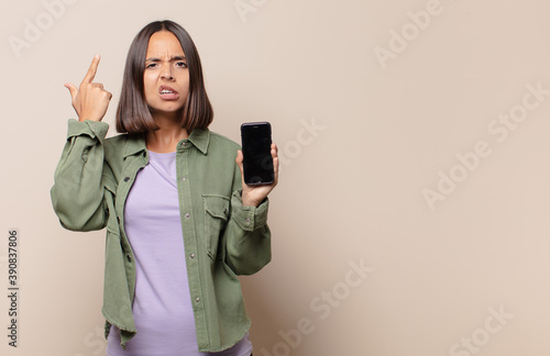 young woman feeling confused and puzzled, showing you are insane, crazy or out of your mind