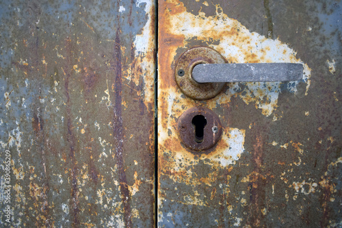 Old rusty texture of metal safe with a handle.